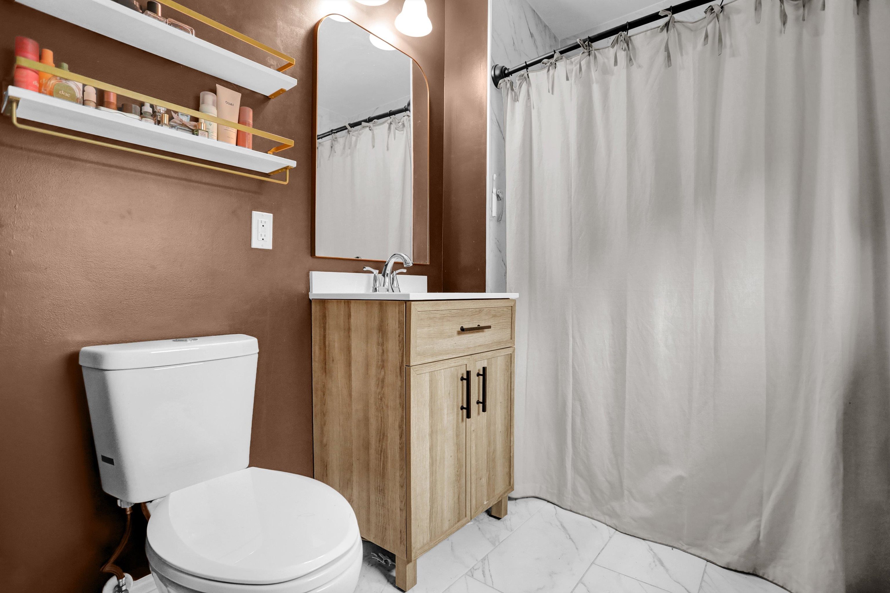 4344 Rhodes Avenue Memphis, TN 38111 - Photo 20 of 31 a white toilet sitting next to a bathroom sink