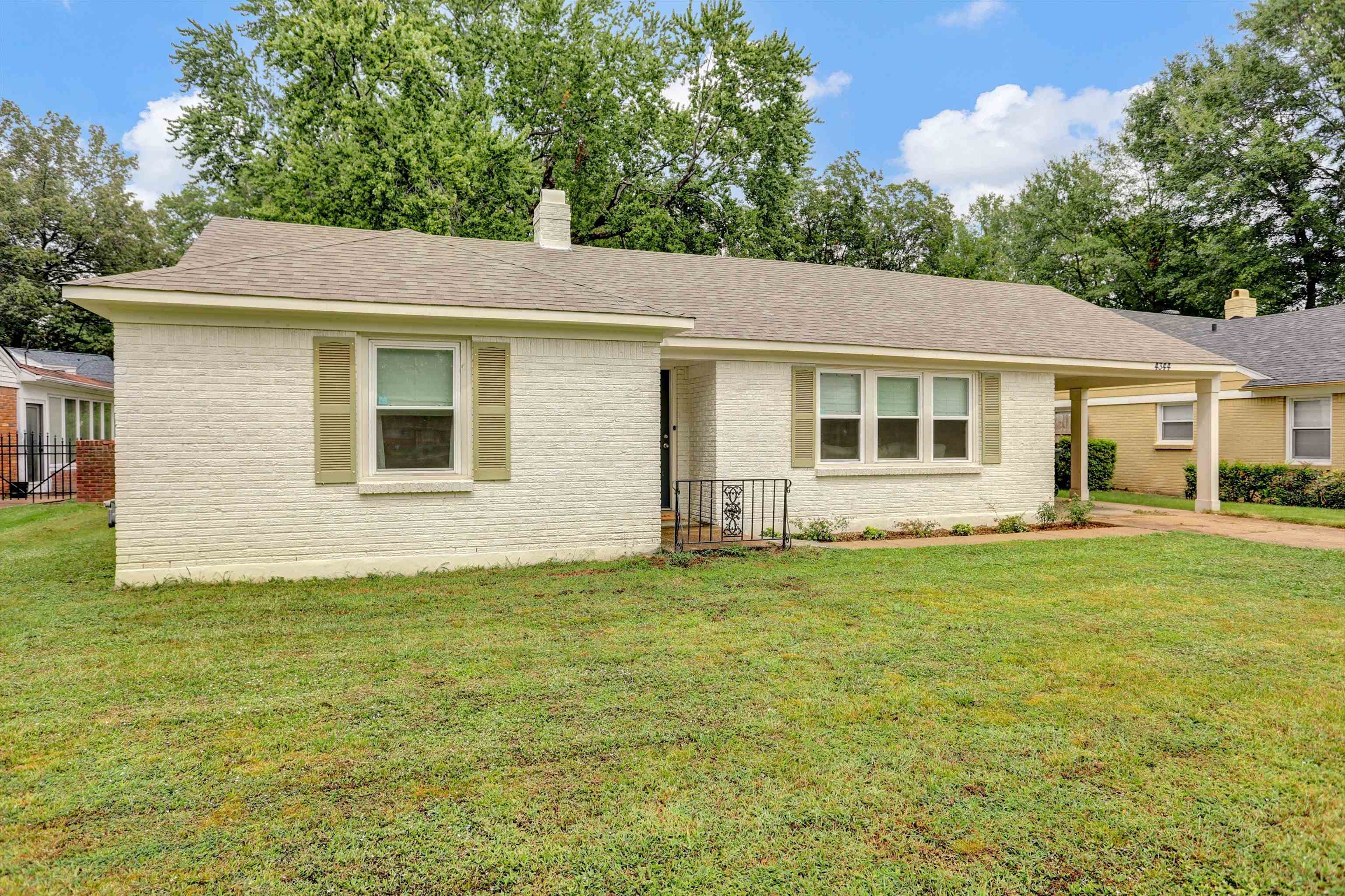 4344 Rhodes Avenue Memphis, TN 38111 - Photo 3 of 31 a backyard of a house with potted plants and large tree