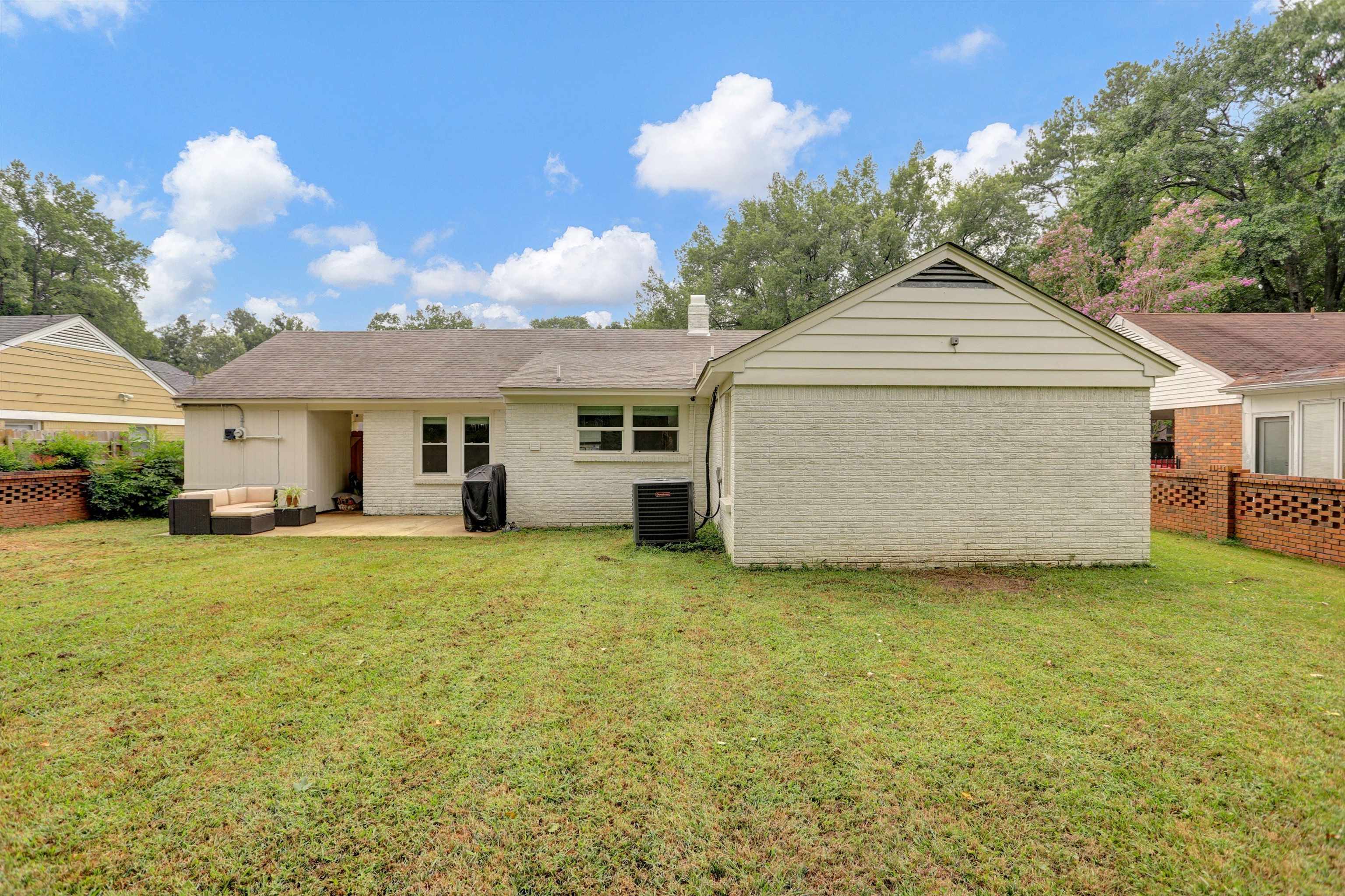 4344 Rhodes Avenue Memphis, TN 38111 - Photo 31 of 31 a front view of a house with a garden and yard