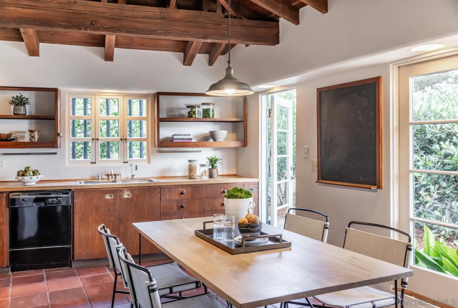 6004 Avenida Cresta La Jolla, CA 92037 - Photo 11 of 58 a kitchen with a table chairs stove and cabinets