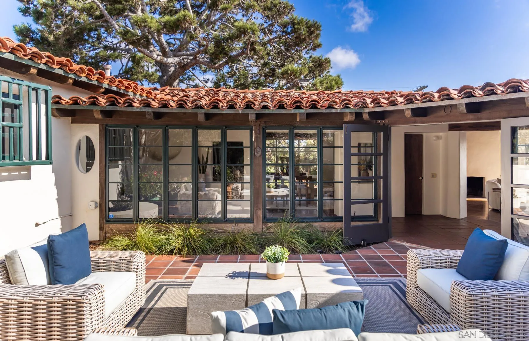 6004 Avenida Cresta La Jolla, CA 92037 - Photo 16 of 58 a view of a patio with couches and table and chairs and potted plants