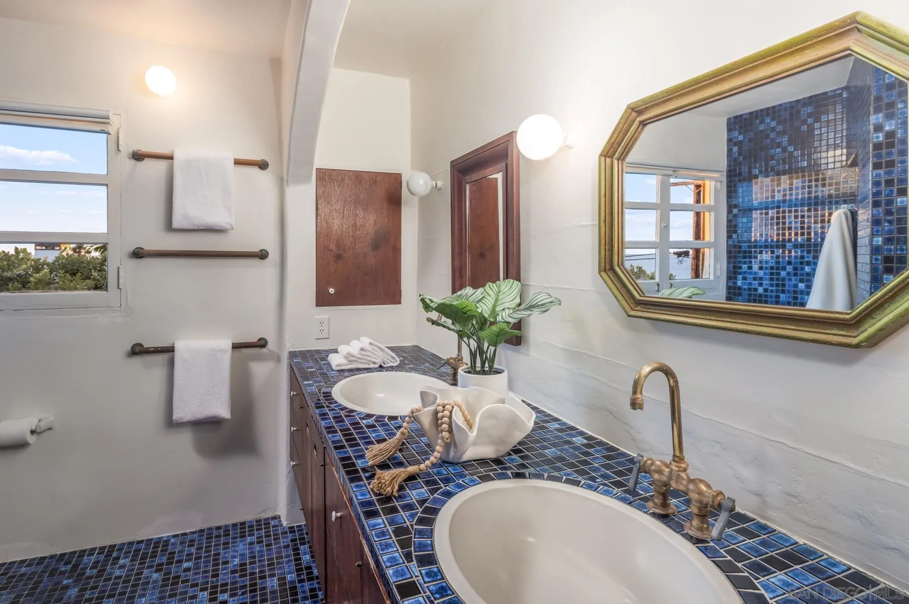 6004 Avenida Cresta La Jolla, CA 92037 - Photo 43 of 58 a bathroom with a granite countertop sink a large mirror and a shower