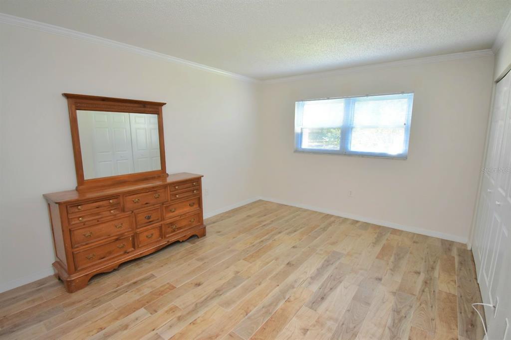 946 Virginia Street, Unit 102 Dunedin, FL 34698 - Photo 15 of 30 a room with a bed and mirror
