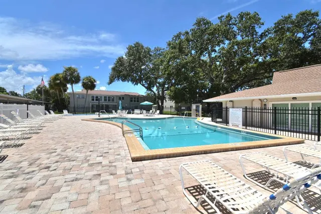 a view of a house with swimming pool and sitting area