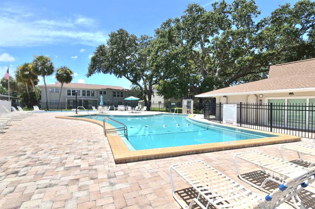 946 Virginia Street, Unit 102 Dunedin, FL 34698 - Photo 28 of 30 a view of a house with swimming pool and sitting area