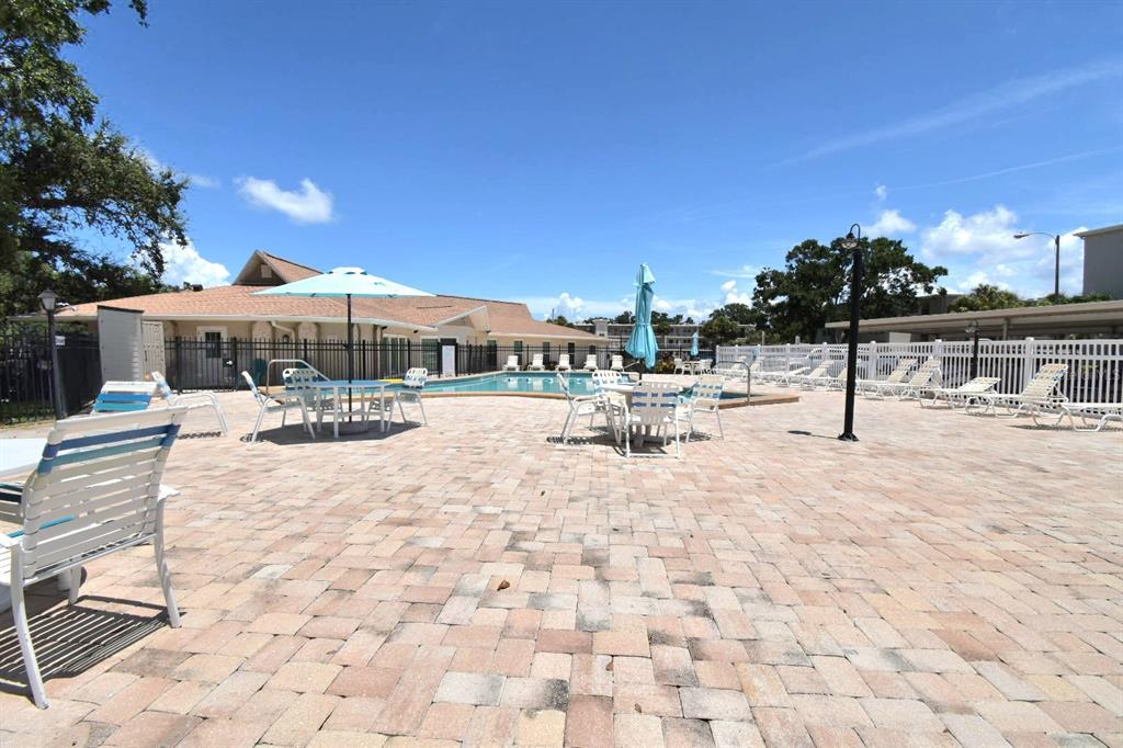 946 Virginia Street, Unit 102 Dunedin, FL 34698 - Photo 30 of 30 a view of swimming pool with outdoor seating