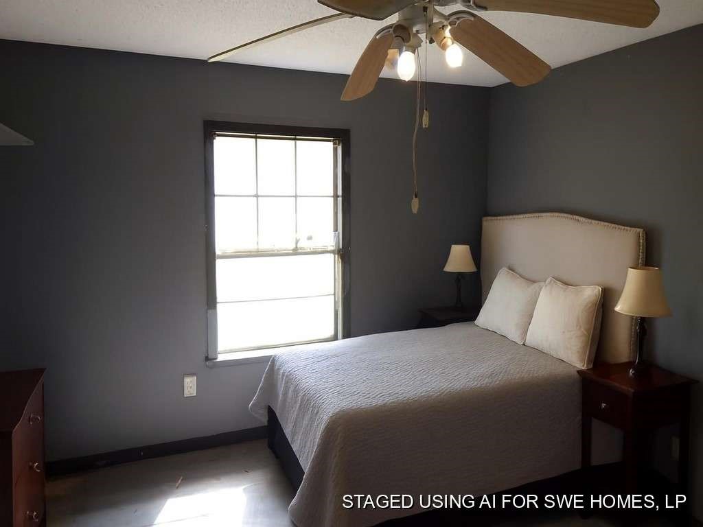 5403 Old State Highway Orange, TX 77632 - Photo 11 of 13 a bed sitting in a bedroom next to a window