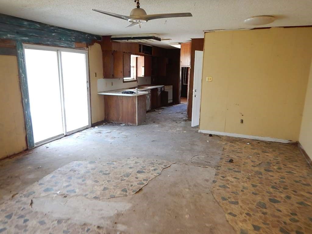 5403 Old State Highway Orange, TX 77632 - Photo 12 of 13 a view of a kitchen with a sink wooden cabinet and stainless steel appliances