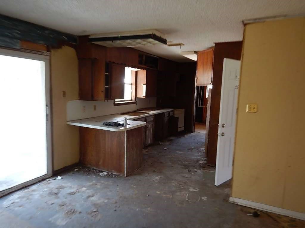 5403 Old State Highway Orange, TX 77632 - Photo 7 of 13 a kitchen with stainless steel appliances granite countertop a stove a refrigerator and a sink