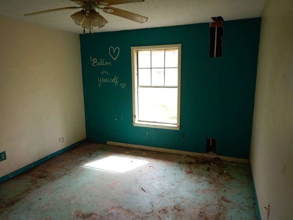 5403 Old State Highway Orange, TX 77632 - Photo 9 of 13 an empty room with a window and a fan