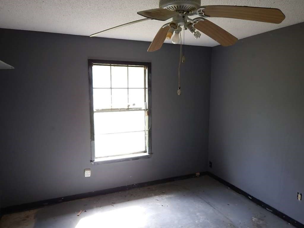 5403 Old State Highway Orange, TX 77632 - Photo 10 of 13 an empty room with a window and a fan