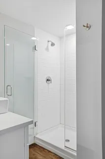 a bathroom with a shower and sink