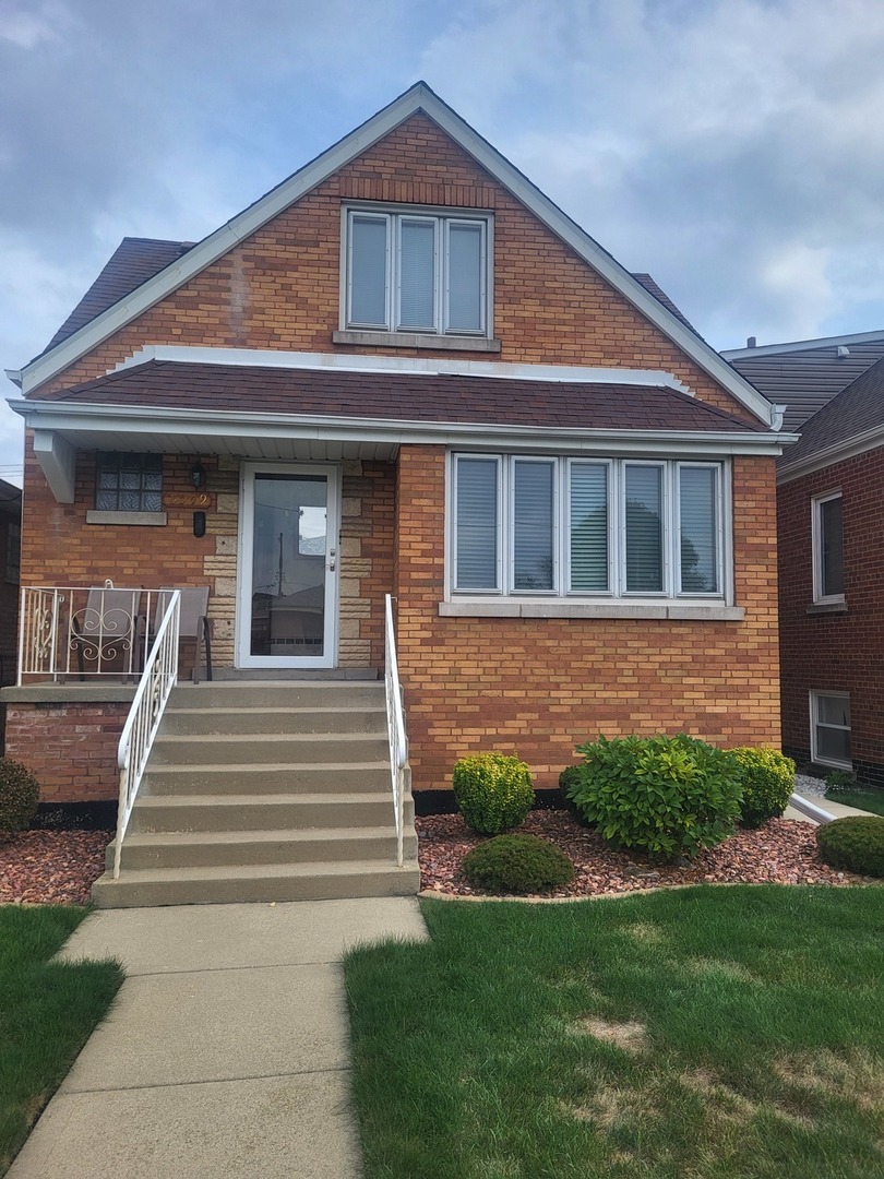 5549 South Meade Avenue, Unit 2 Chicago, IL 60638 - Photo 1 of 7 a front view of a house with a garden