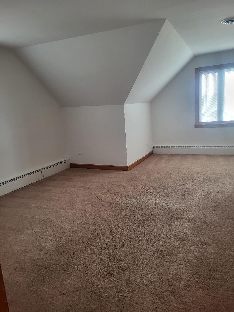 5549 South Meade Avenue, Unit 2 Chicago, IL 60638 - Photo 2 of 7 a view of an empty room and window