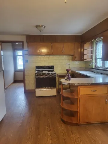 a kitchen with stainless steel appliances a stove a sink and a microwave