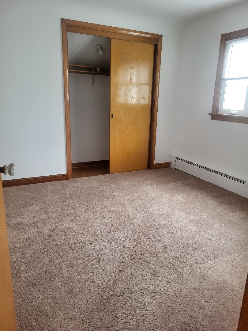 5549 South Meade Avenue, Unit 2 Chicago, IL 60638 - Photo 6 of 7 an empty room with a door