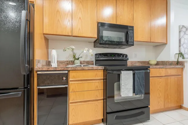 a kitchen with stainless steel appliances granite countertop a refrigerator and a stove