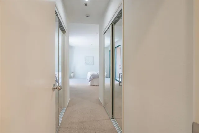 a bedroom with a bed and a night stand