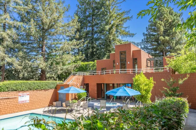 an outdoor space with patio and white umbrellas