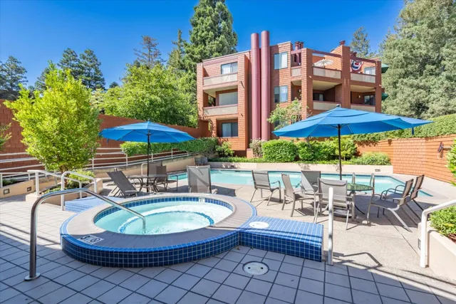 a living room with furniture and large windows