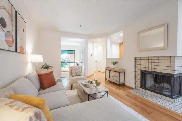 a living room with furniture fireplace and a large window
