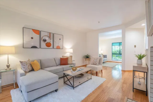 a living room with furniture and painting on the wall