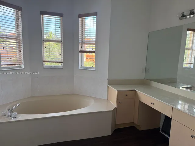 a bath tub sitting next to a window