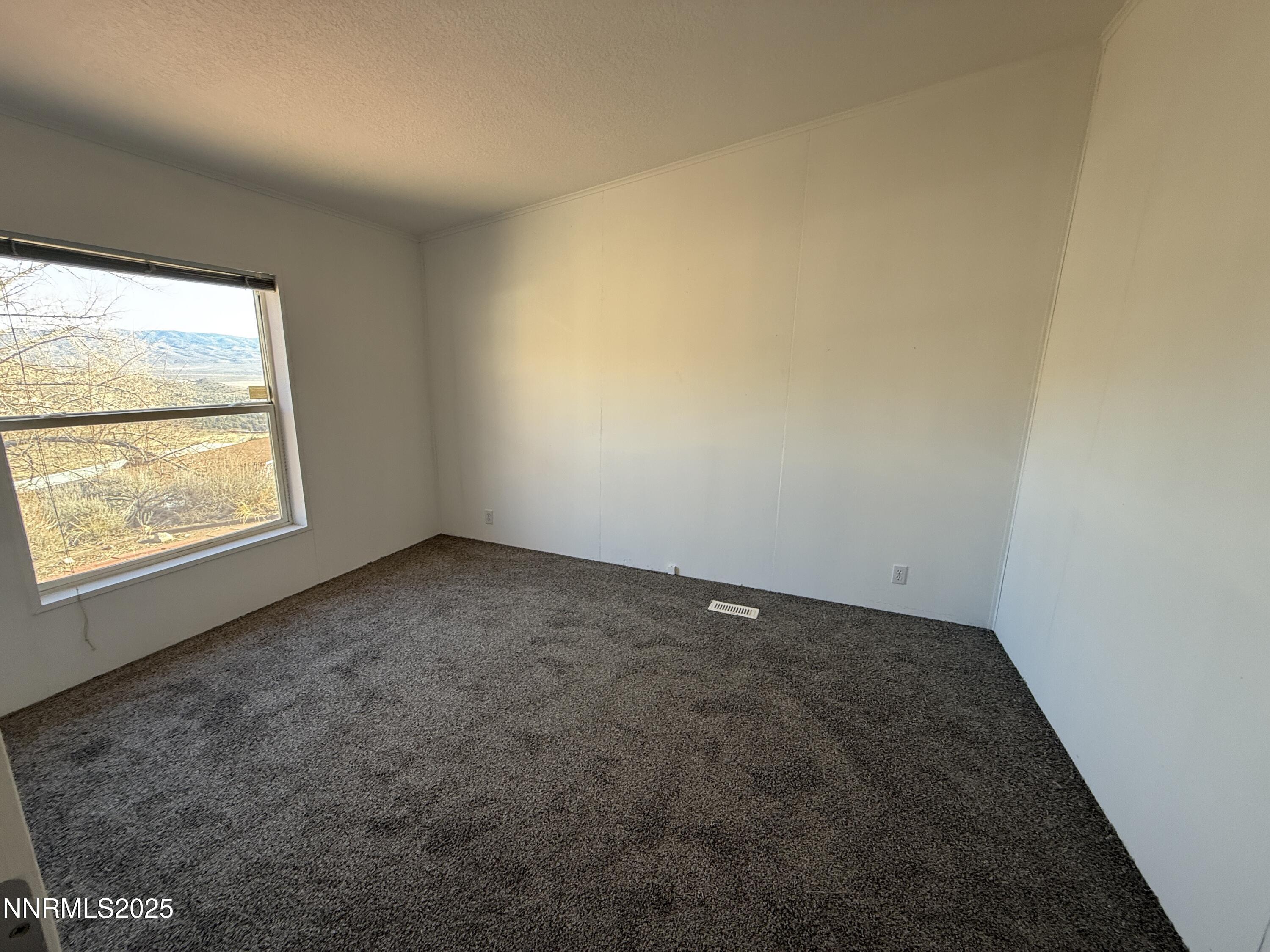 1166 Slate Road Topaz Ranch Estates, NV 89444 - Photo 16 of 31 an empty room with a window