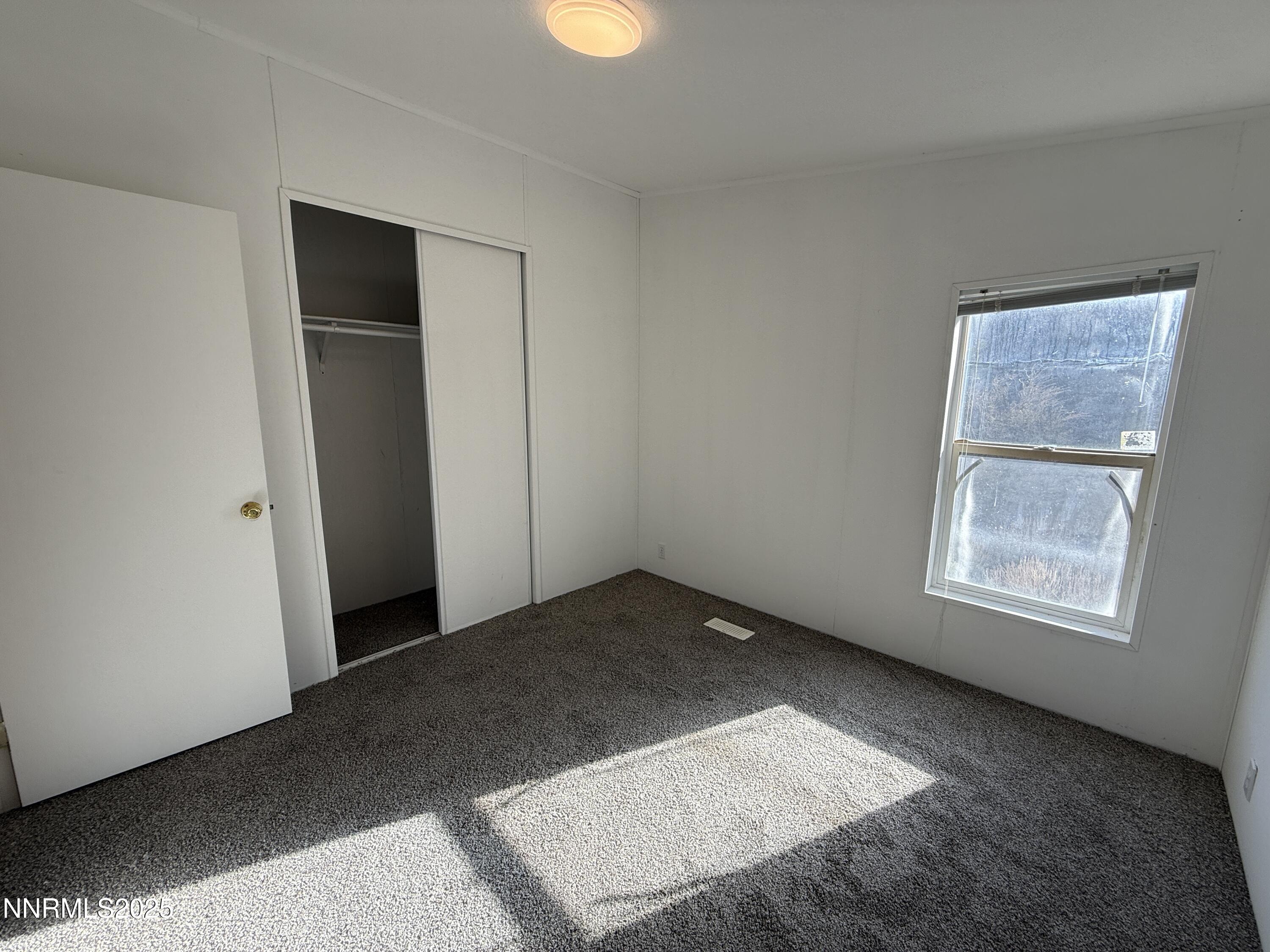 1166 Slate Road Topaz Ranch Estates, NV 89444 - Photo 21 of 31 an empty room with windows and closet
