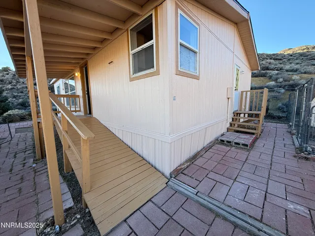 a view of a backyard with sitting area