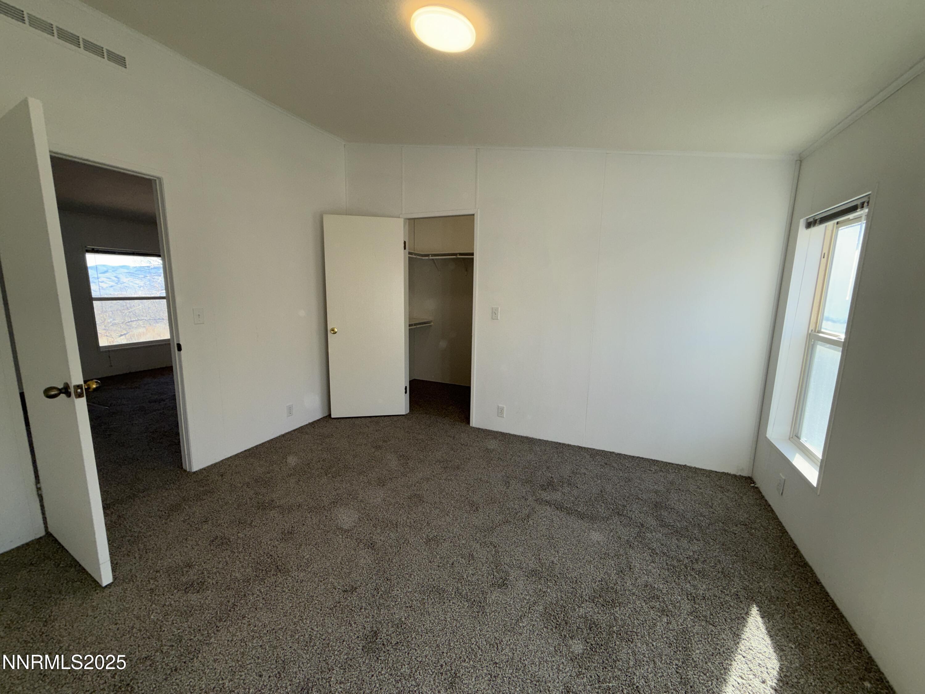 1166 Slate Road Topaz Ranch Estates, NV 89444 - Photo 10 of 31 an empty room with closet and mirror