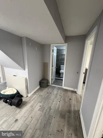 a view of a livingroom with wooden floor and furniture
