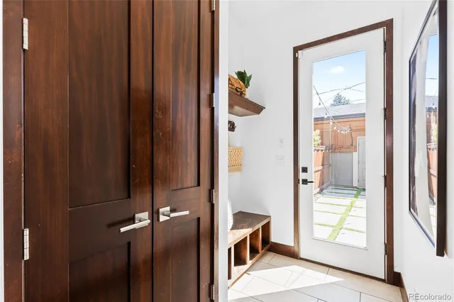 a living room with furniture a fireplace and a table with wooden floor