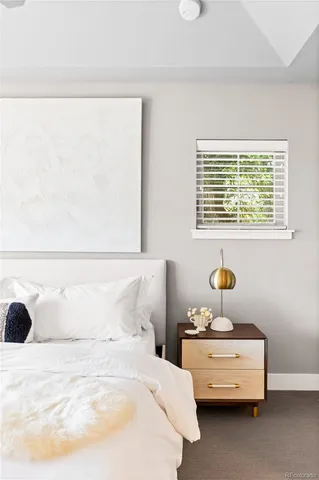 a view of a house with large trees and plants