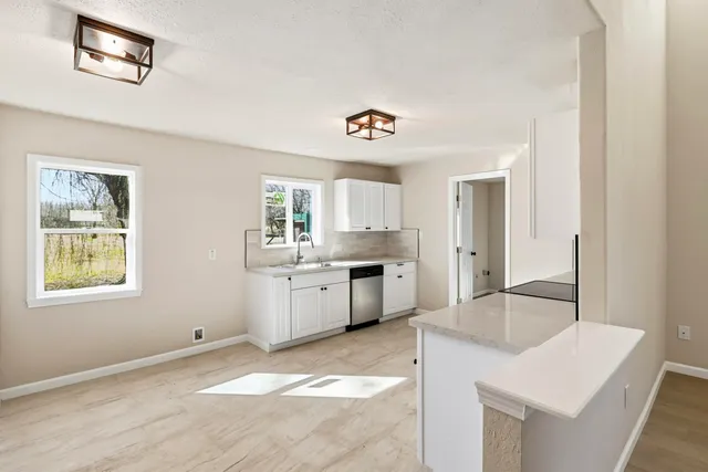 a kitchen with a refrigerator and a sink