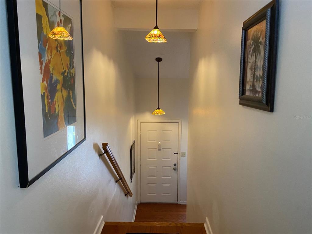 11450 Harbor Way, Unit 5002 Largo, FL 33774 - Photo 5 of 25 a view of a hallway with wooden floor and stairs