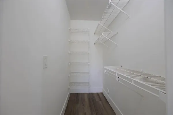 a view of walk in closet with empty racks