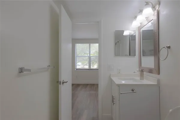 a bathroom with a sink mirror and shower