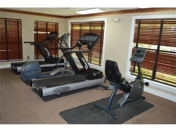 a living room with gym equipment and a large window