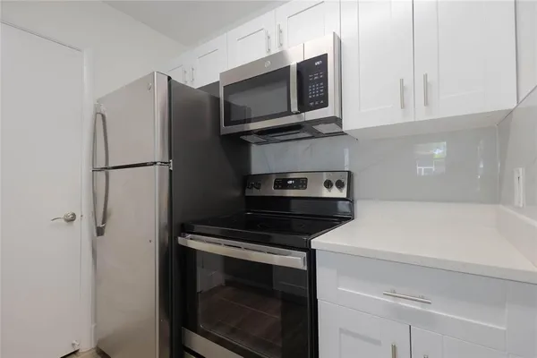 a kitchen with a stove and a microwave