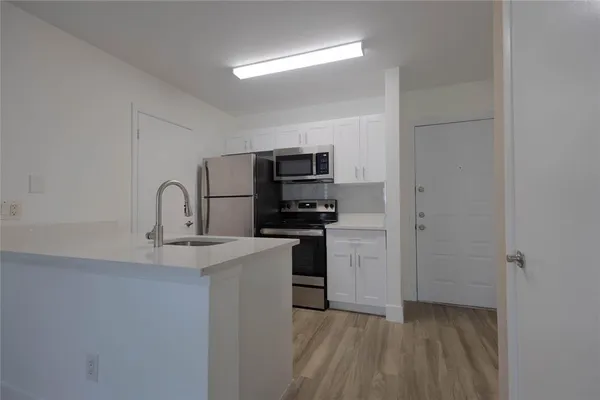 a kitchen with a sink and a stove
