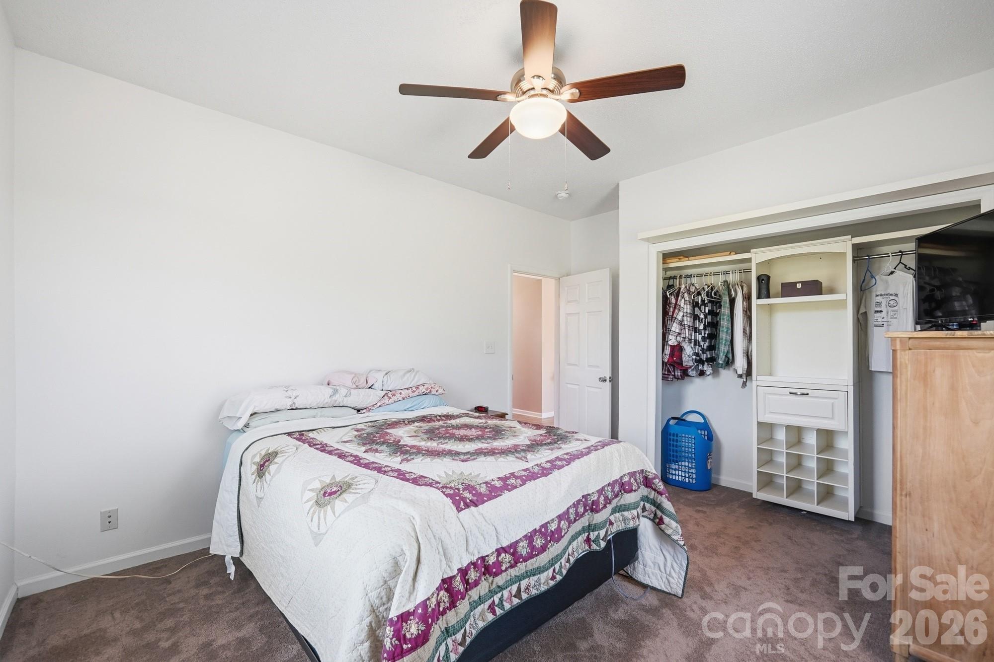 4415 Old Monroe Marshville Road Wingate, NC 28174 - Photo 15 of 28 a bedroom with a bed and a chandelier