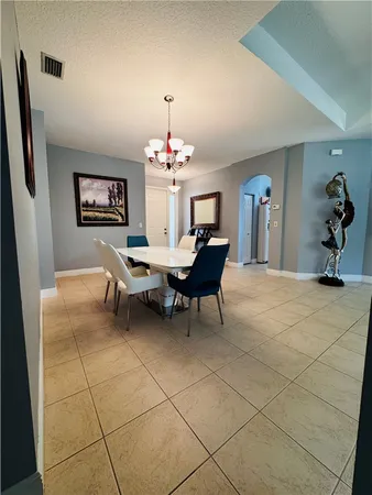 a dining room with furniture and a chandelier