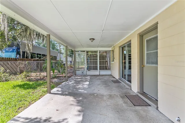a view of a house with backyard and porch