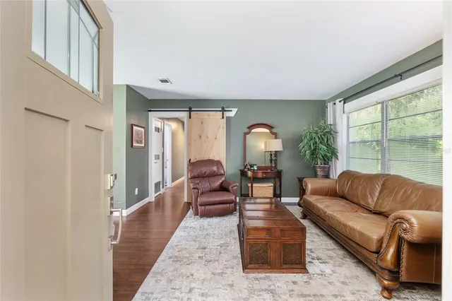 a living room with furniture and a large window