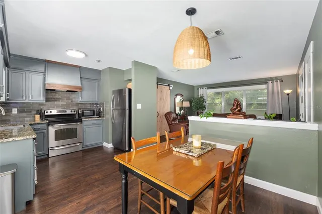 a kitchen with stainless steel appliances granite countertop a sink stove and cabinets