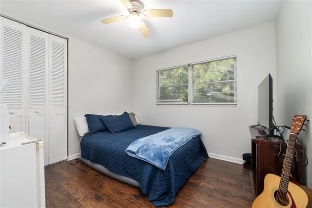 a view of a yard with plants and trees