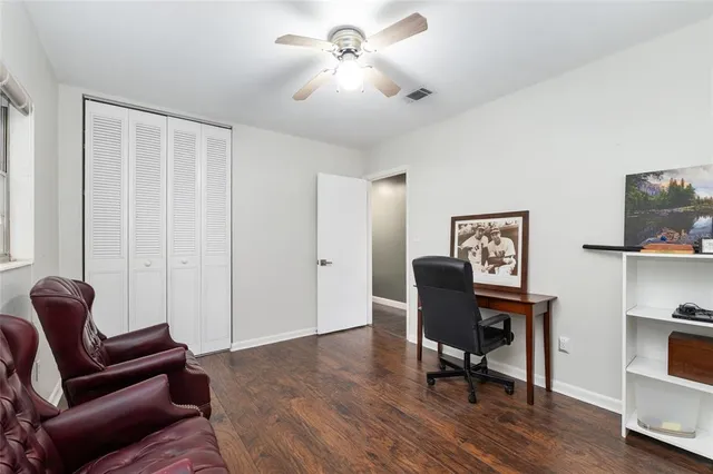 a view of a yard with plants and trees