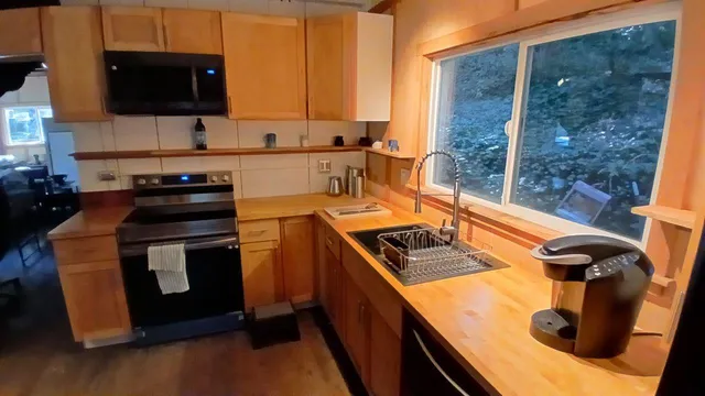 a kitchen with a stove a sink and a microwave
