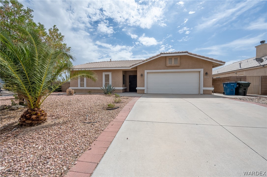 5762 Ruth Drive Fort Mohave, AZ 86426 - Photo 1 of 29 a front view of a house with a yard and garage
